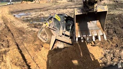 getting skid steer stuck out of work|skid steer stuck in mud.